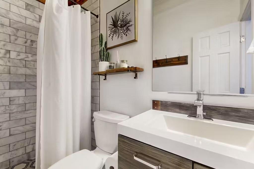153 Randolph Street Northeast Atlanta, GA 30312 - Photo 16 of 37 a bathroom with a sink and a toilet