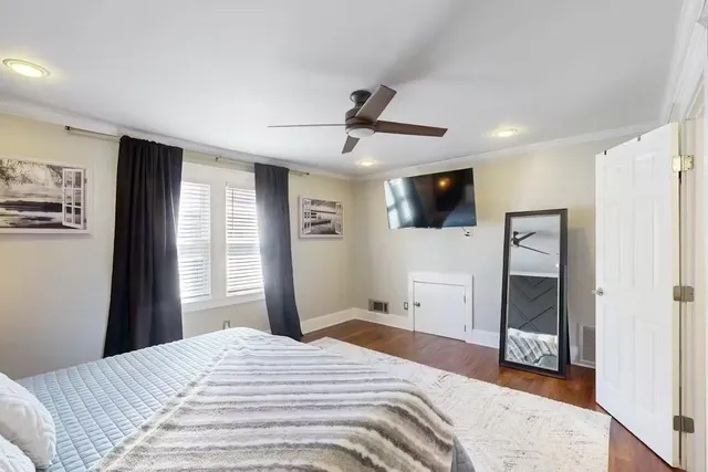a bathroom with a bathtub shower sink mirror and toilet