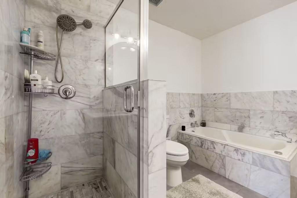 153 Randolph Street Northeast Atlanta, GA 30312 - Photo 21 of 37 a bathroom with a bathtub shower sink mirror and toilet