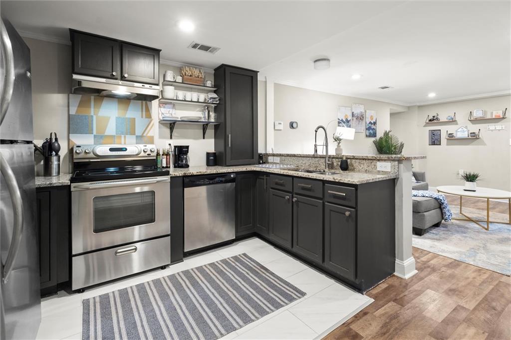153 Randolph Street Northeast Atlanta, GA 30312 - Photo 27 of 37 a kitchen with a stove sink and cabinets