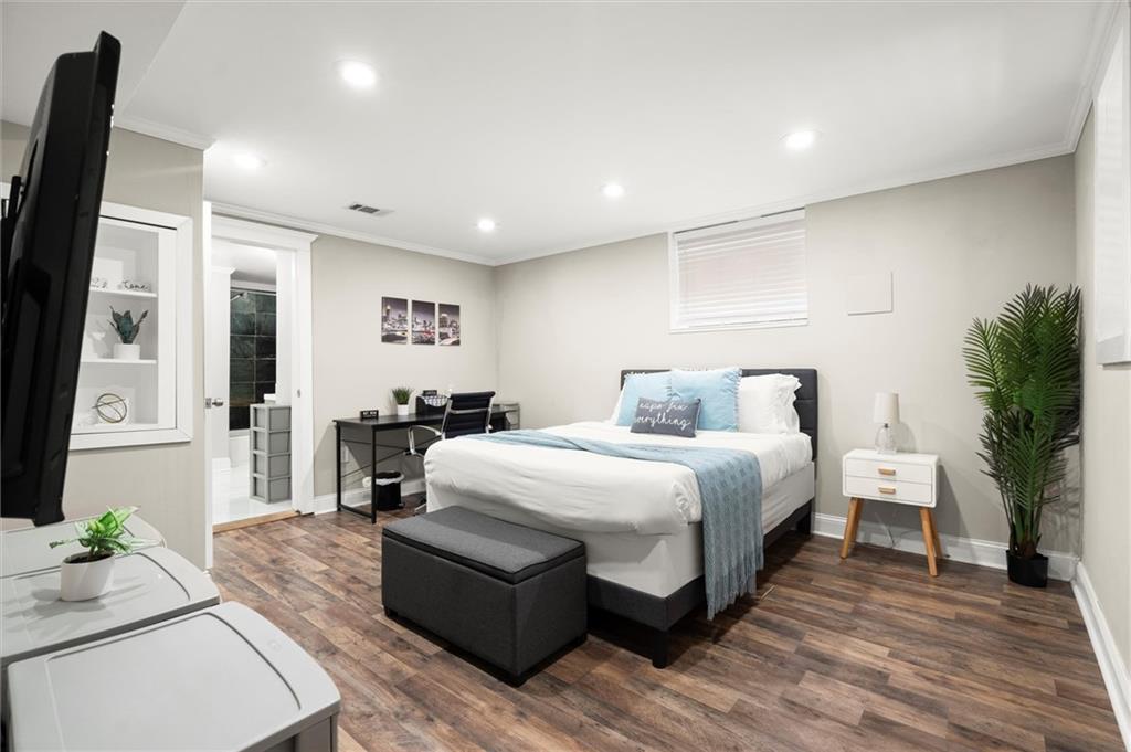 153 Randolph Street Northeast Atlanta, GA 30312 - Photo 29 of 37 a spacious bedroom with a bed and a couch