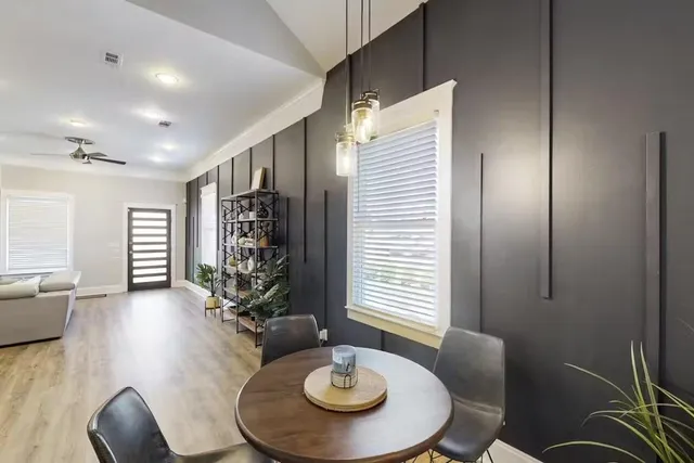 a living room with furniture and wooden floor