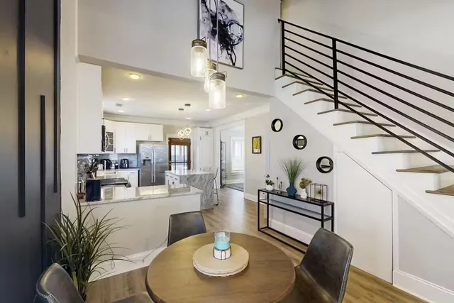 a kitchen with stainless steel appliances granite countertop a stove top oven a refrigerator a sink and a center island