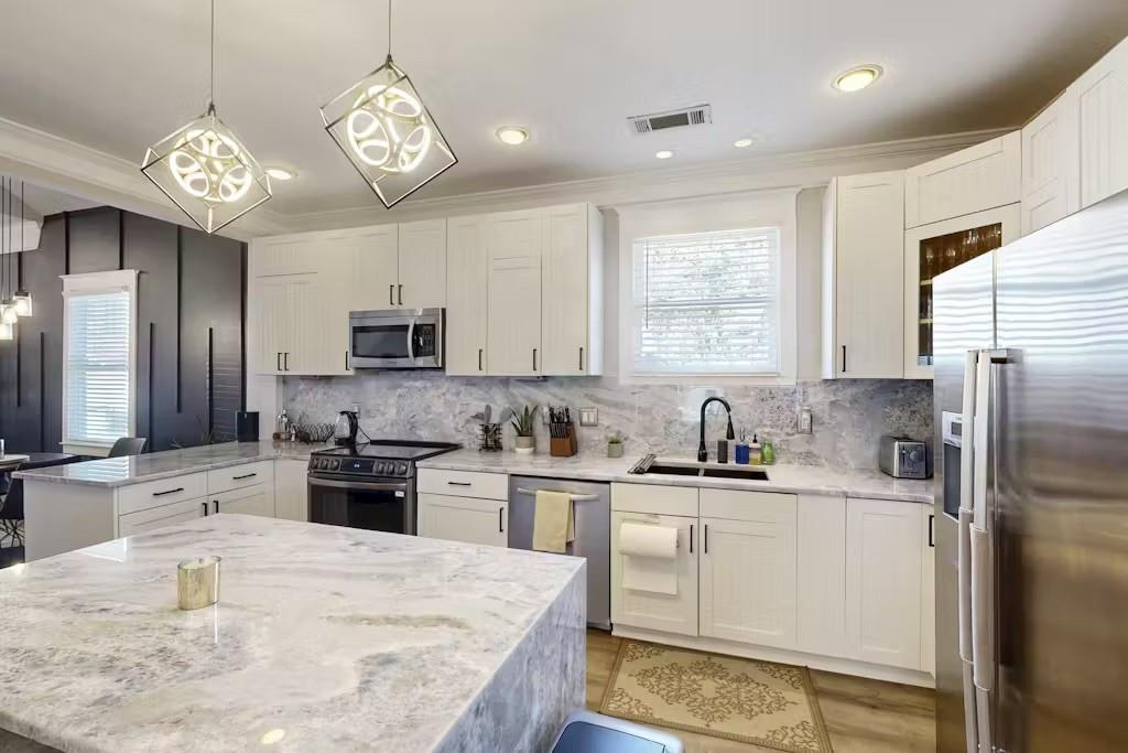 153 Randolph Street Northeast Atlanta, GA 30312 - Photo 10 of 37 a kitchen with stainless steel appliances granite countertop a sink stove refrigerator and microwave