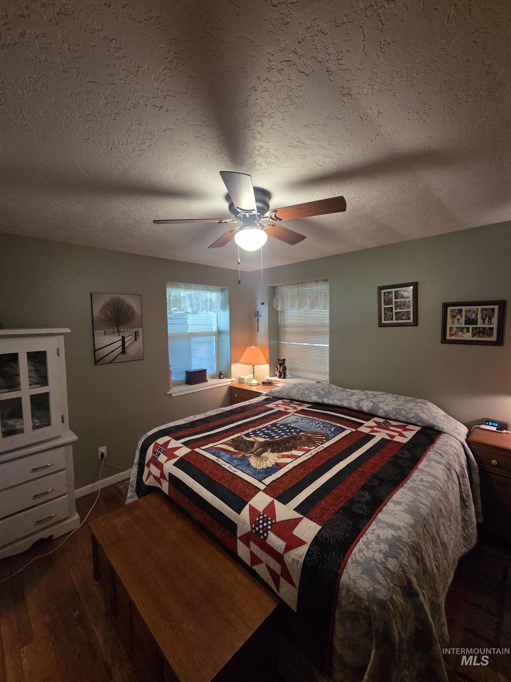 109 South 3rd Street Pomeroy, WA 99347 - Photo 11 of 36 Bedroom featuring light green wall paint and wood-finish flooring