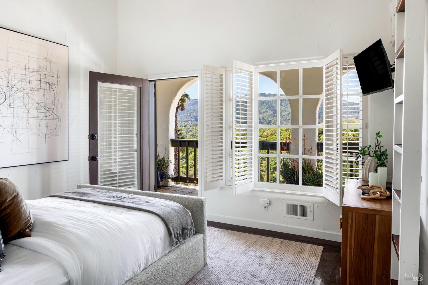 4377 Warm Springs Road Glen Ellen, CA 95442 - Photo 23 of 56 a bedroom with a large window and a flat screen tv