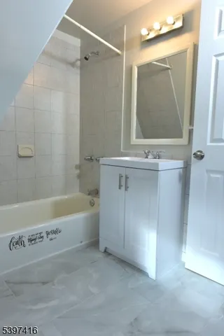 a bathroom with a bathtub and a sink