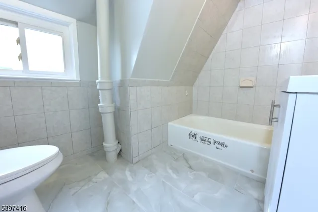 a bathroom with a bathtub and toilet
