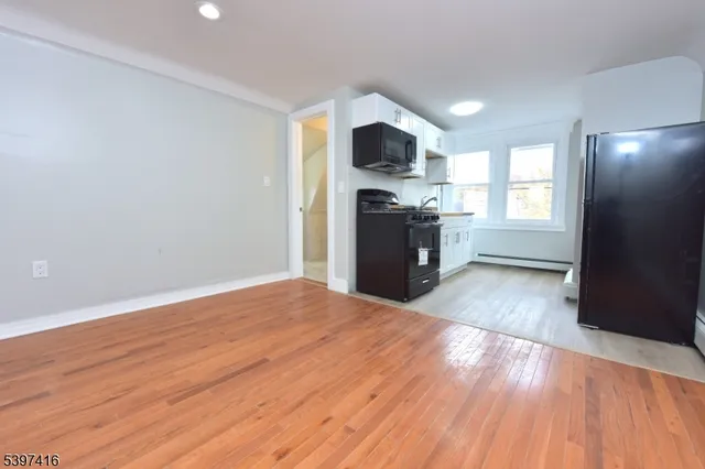 a view of kitchen with sink microwave and refrigerator