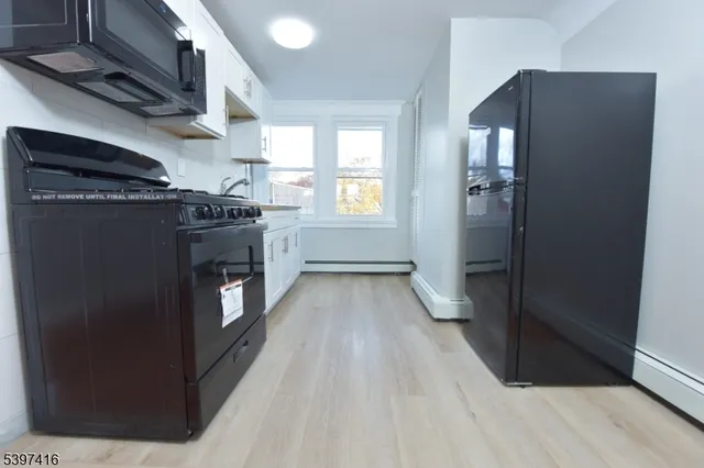 a kitchen with stainless steel appliances granite countertop a refrigerator and a stove