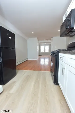 a view of a kitchen with a stove cabinets and a wooden floor