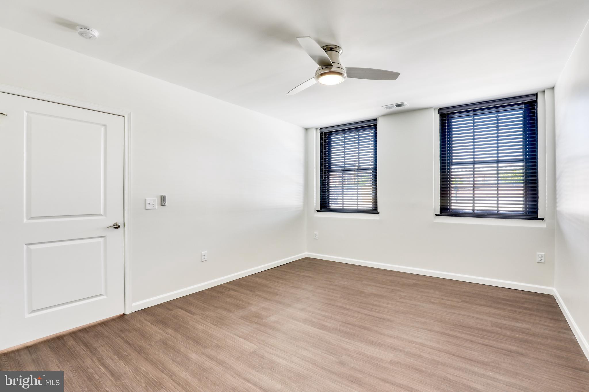 210 East Boscawen Street, Unit 203 Winchester, VA 22601 - Photo 13 of 27 a view of empty room with wooden floor and fan