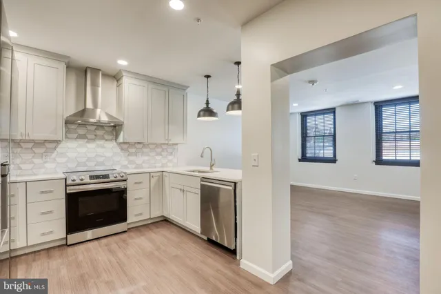 a kitchen with stainless steel appliances granite countertop a stove and a sink