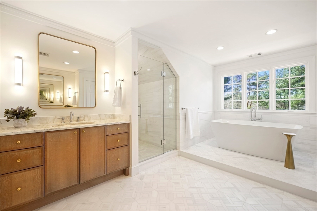 1 Myles Standish Road Weston, MA 02493 - Photo 18 of 40 a spacious bathroom with a granite countertop tub sink shower and mirror