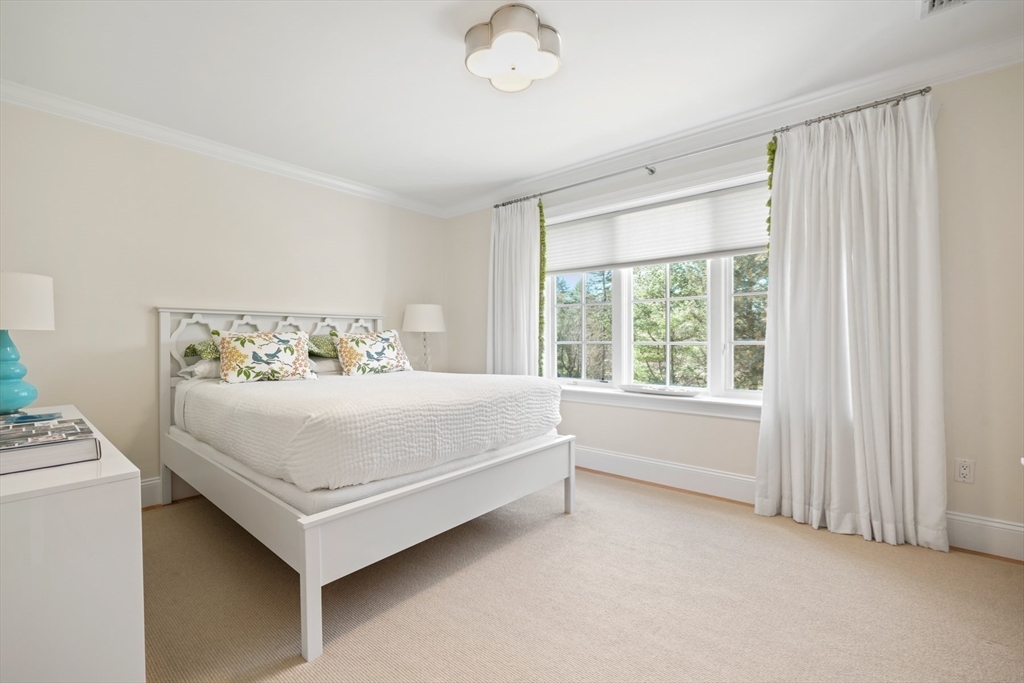 1 Myles Standish Road Weston, MA 02493 - Photo 19 of 40 a white bed sitting in a room next to a window