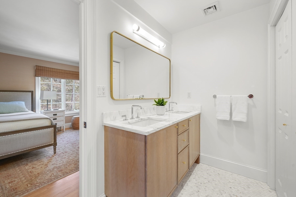 1 Myles Standish Road Weston, MA 02493 - Photo 23 of 40 a en suite bathroom with a granite countertop sink and a mirror