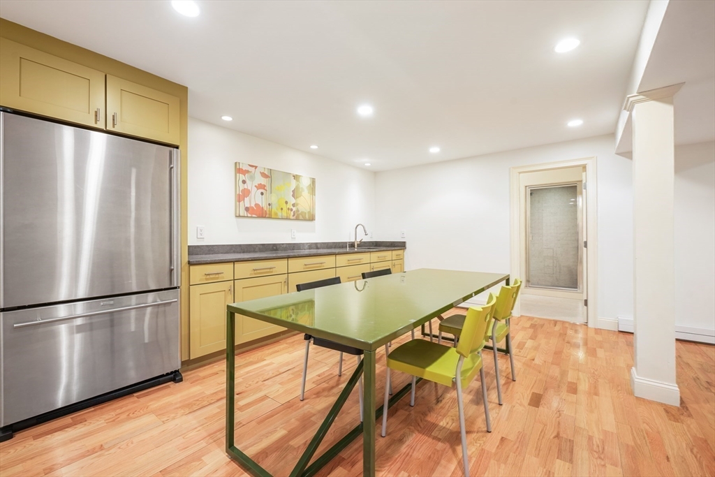 1 Myles Standish Road Weston, MA 02493 - Photo 27 of 40 a kitchen with stainless steel appliances granite countertop a refrigerator a table and chairs