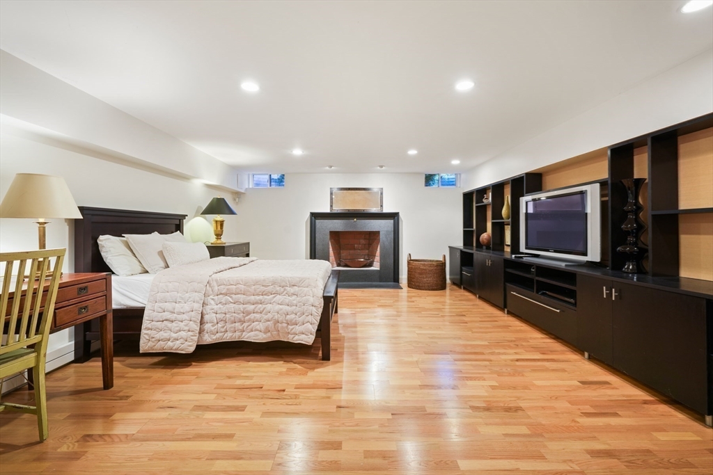 1 Myles Standish Road Weston, MA 02493 - Photo 28 of 40 a bedroom with a bed and a flat screen tv