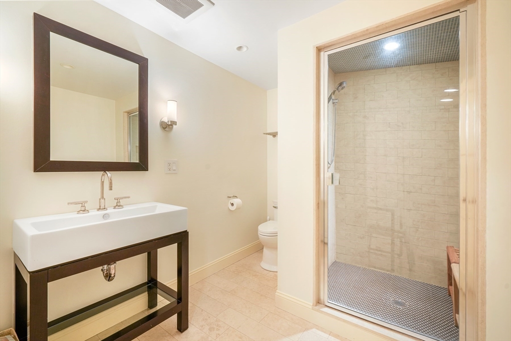 1 Myles Standish Road Weston, MA 02493 - Photo 30 of 40 a bathroom with a sink a toilet and shower