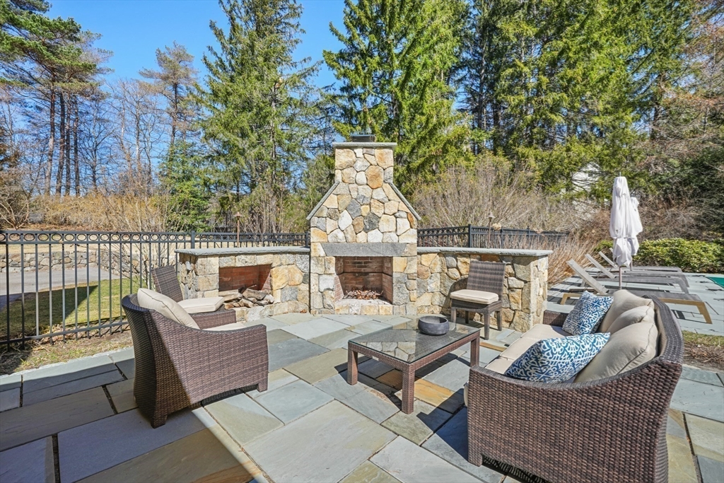 1 Myles Standish Road Weston, MA 02493 - Photo 33 of 40 an outdoor living area with furniture and a fireplace