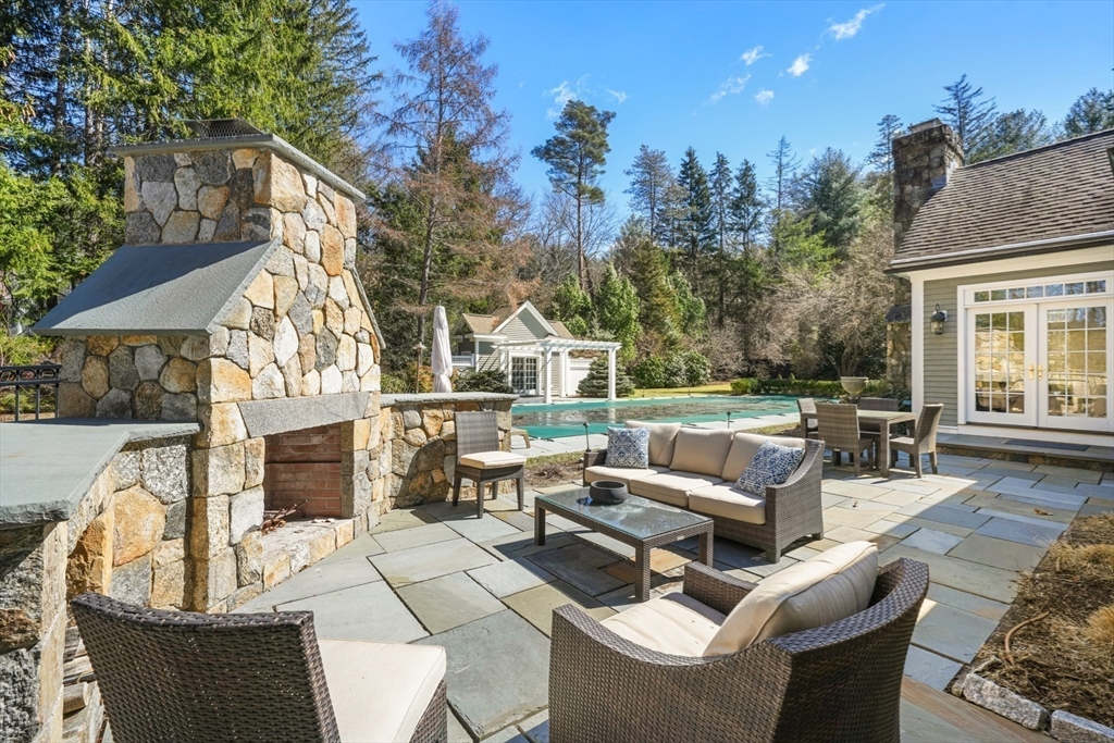 1 Myles Standish Road Weston, MA 02493 - Photo 34 of 40 a view of a patio with couches table and chairs and potted plants