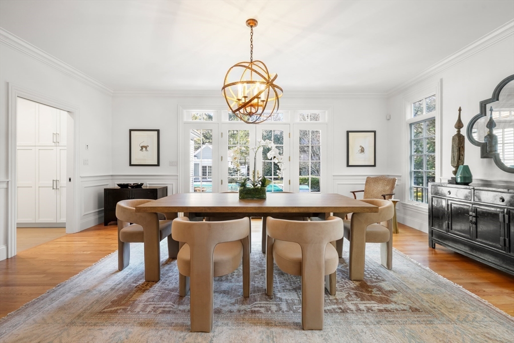 1 Myles Standish Road Weston, MA 02493 - Photo 6 of 40 a dining room with wooden floor a chandelier a wooden table and chairs