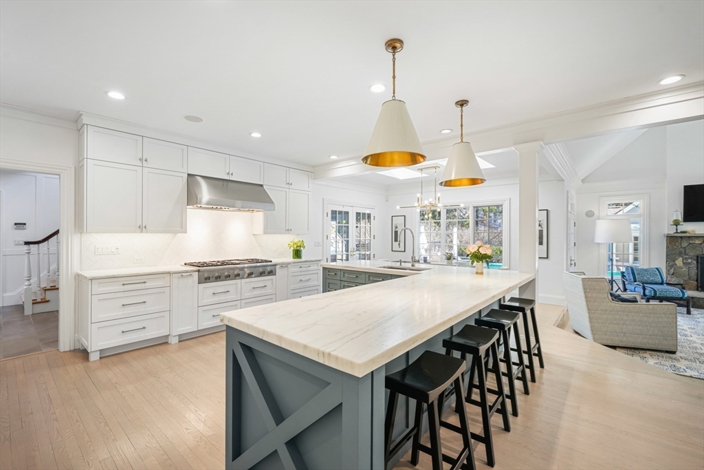 1 Myles Standish Road Weston, MA 02493 - Photo 9 of 40 a kitchen with stainless steel appliances a stove a table a stove and a refrigerator