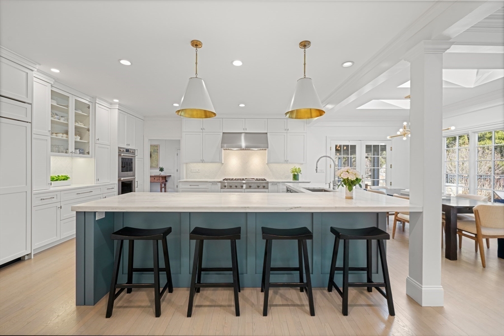 1 Myles Standish Road Weston, MA 02493 - Photo 10 of 40 a kitchen with kitchen island granite countertop wooden cabinets and chairs