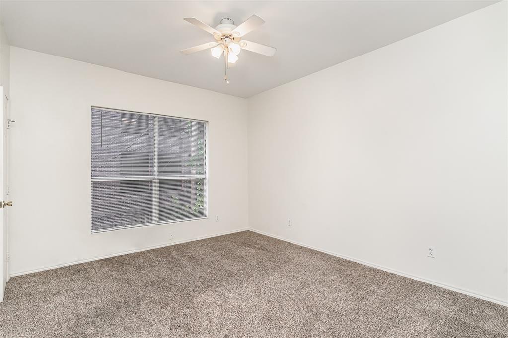 3329 Rosedale Avenue, Unit 21 University Park, TX 75205 - Photo 16 of 24 Carpeted empty room with ceiling fan and baseboards