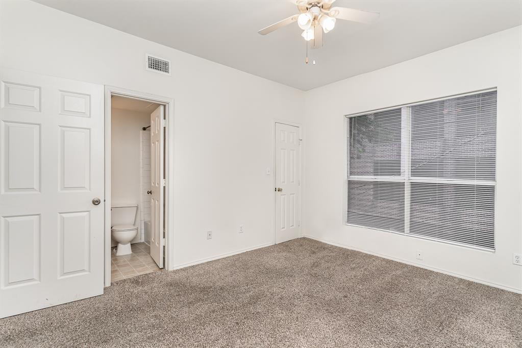 3329 Rosedale Avenue, Unit 21 University Park, TX 75205 - Photo 17 of 24 Unfurnished bedroom with carpet, ensuite bathroom, and a ceiling fan