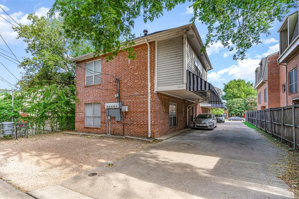 3329 Rosedale Avenue, Unit 21 University Park, TX 75205 - Photo 23 of 24 View of home's exterior with brick siding and concrete driveway
