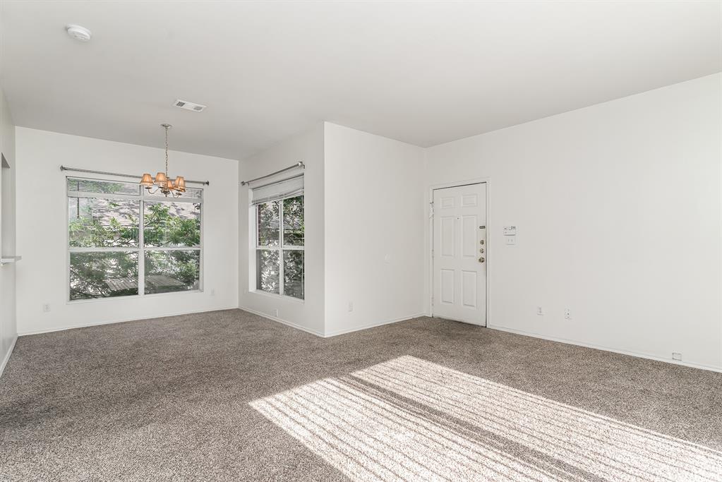 3329 Rosedale Avenue, Unit 21 University Park, TX 75205 - Photo 3 of 24 Carpeted spare room featuring a chandelier and baseboards
