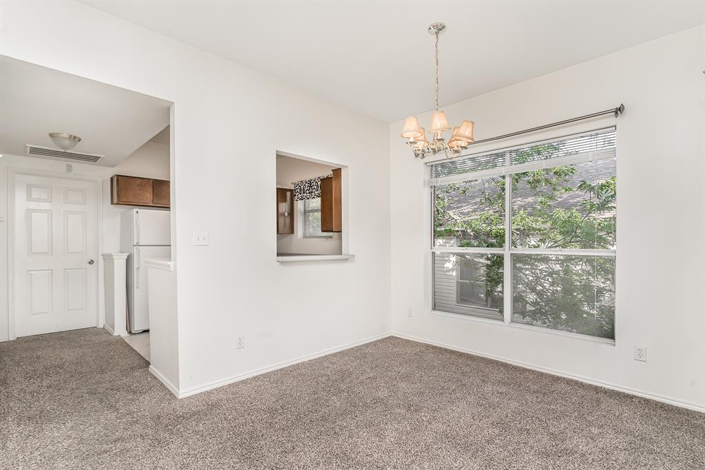 3329 Rosedale Avenue, Unit 21 University Park, TX 75205 - Photo 6 of 24 Spare room with light carpet and a chandelier