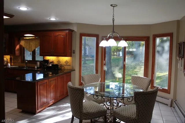 a dining room with furniture a chandelier and window