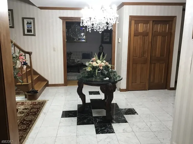 a dining room with furniture and a chandelier