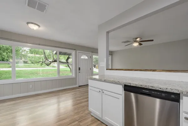 a kitchen with a sink and large window