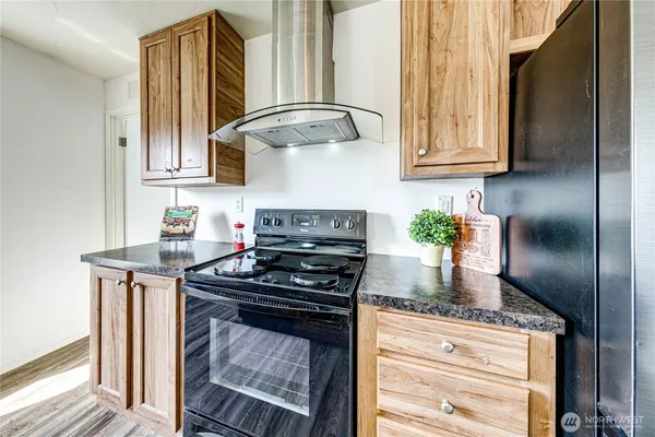 a kitchen with stainless steel appliances granite countertop a stove a sink and a refrigerator