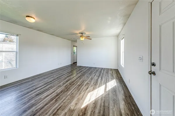wooden floor in an empty room with a window