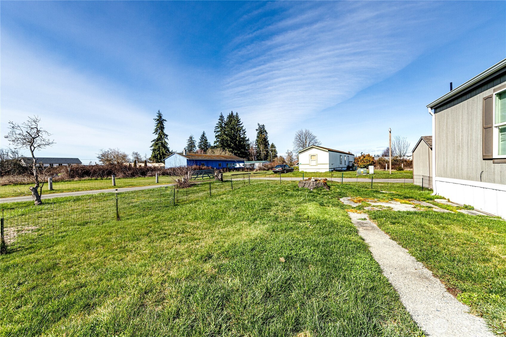 491 Mill Road, Unit 8 Sequim, WA 98382 - Photo 21 of 37 a view of a backyard with table and chairs