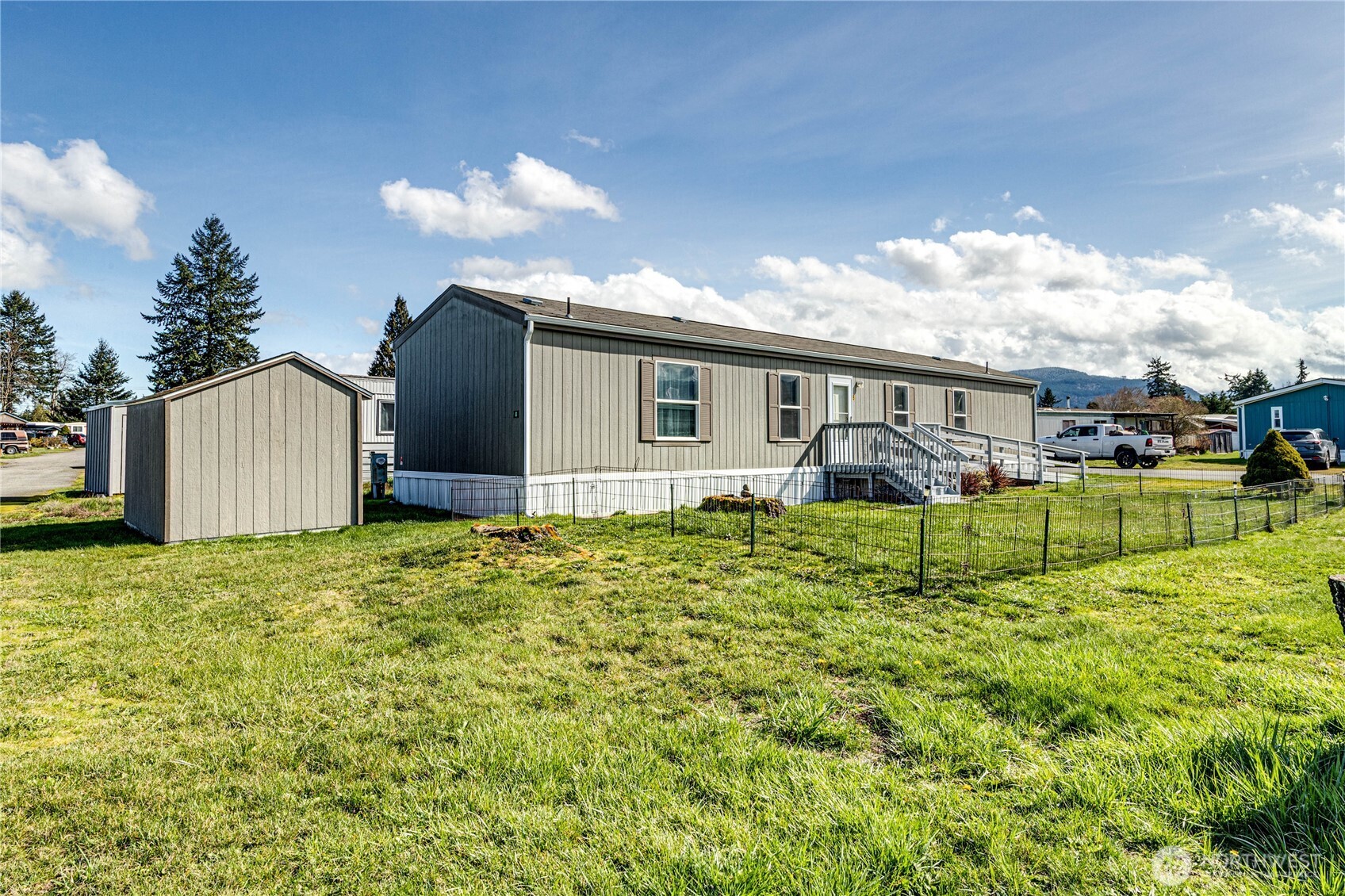 491 Mill Road, Unit 8 Sequim, WA 98382 - Photo 22 of 37 a view of a house with backyard and sitting area