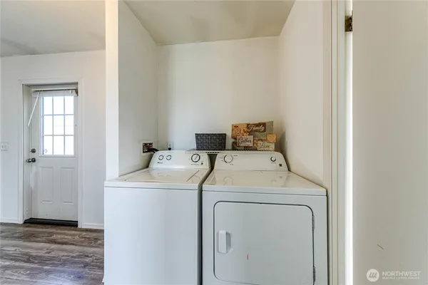 a view of a room with wooden floor and window