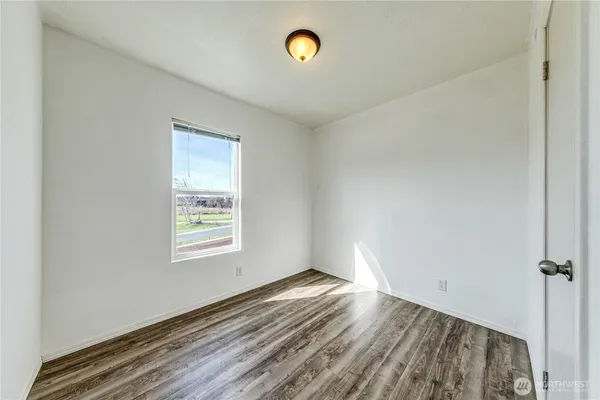 a bathroom with a granite countertop sink a toilet and tub
