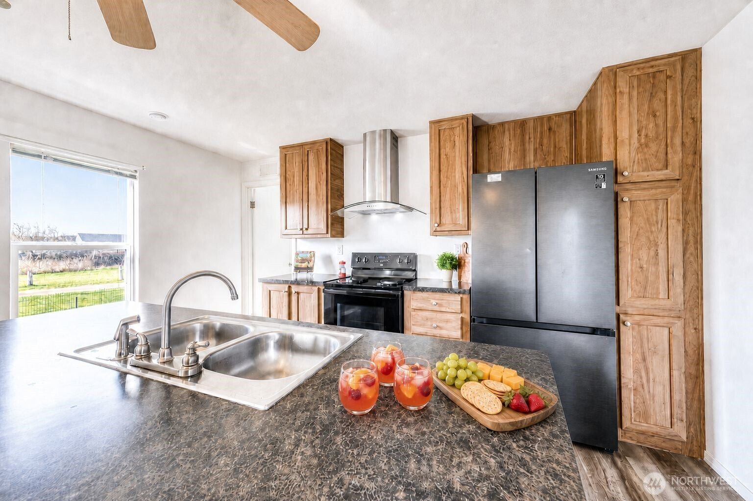 491 Mill Road, Unit 8 Sequim, WA 98382 - Photo 30 of 37 a kitchen with granite countertop a refrigerator and a stove
