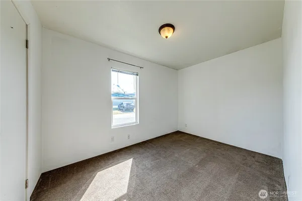 a view of a backyard with wooden fence