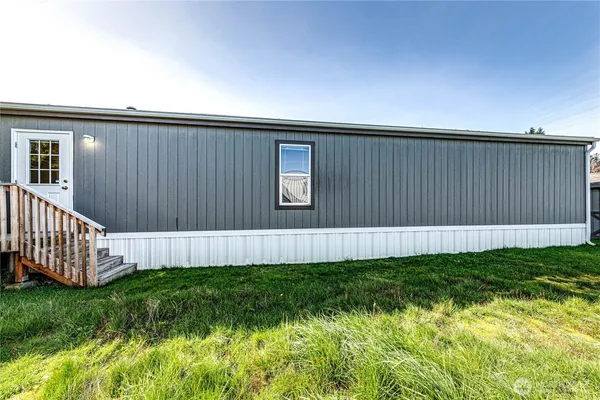 a view of a house with backyard and sitting area