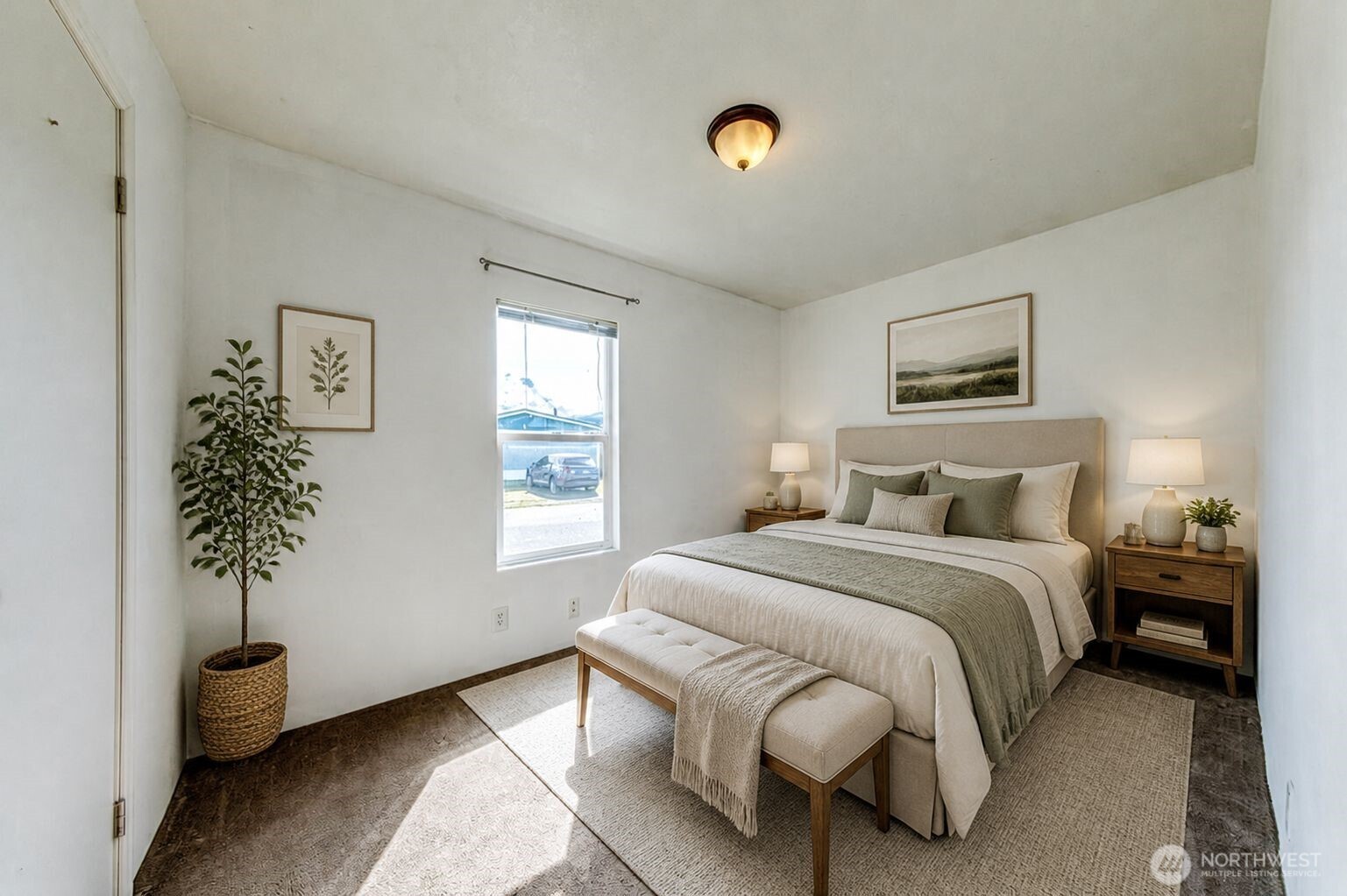 491 Mill Road, Unit 8 Sequim, WA 98382 - Photo 33 of 37 a bedroom with a bed and a potted plant