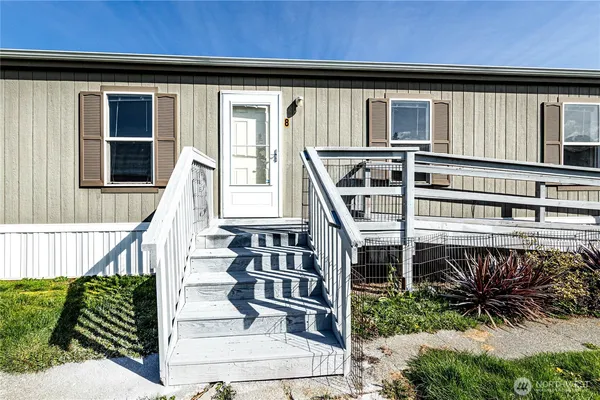 a front view of a house with a wooden deck