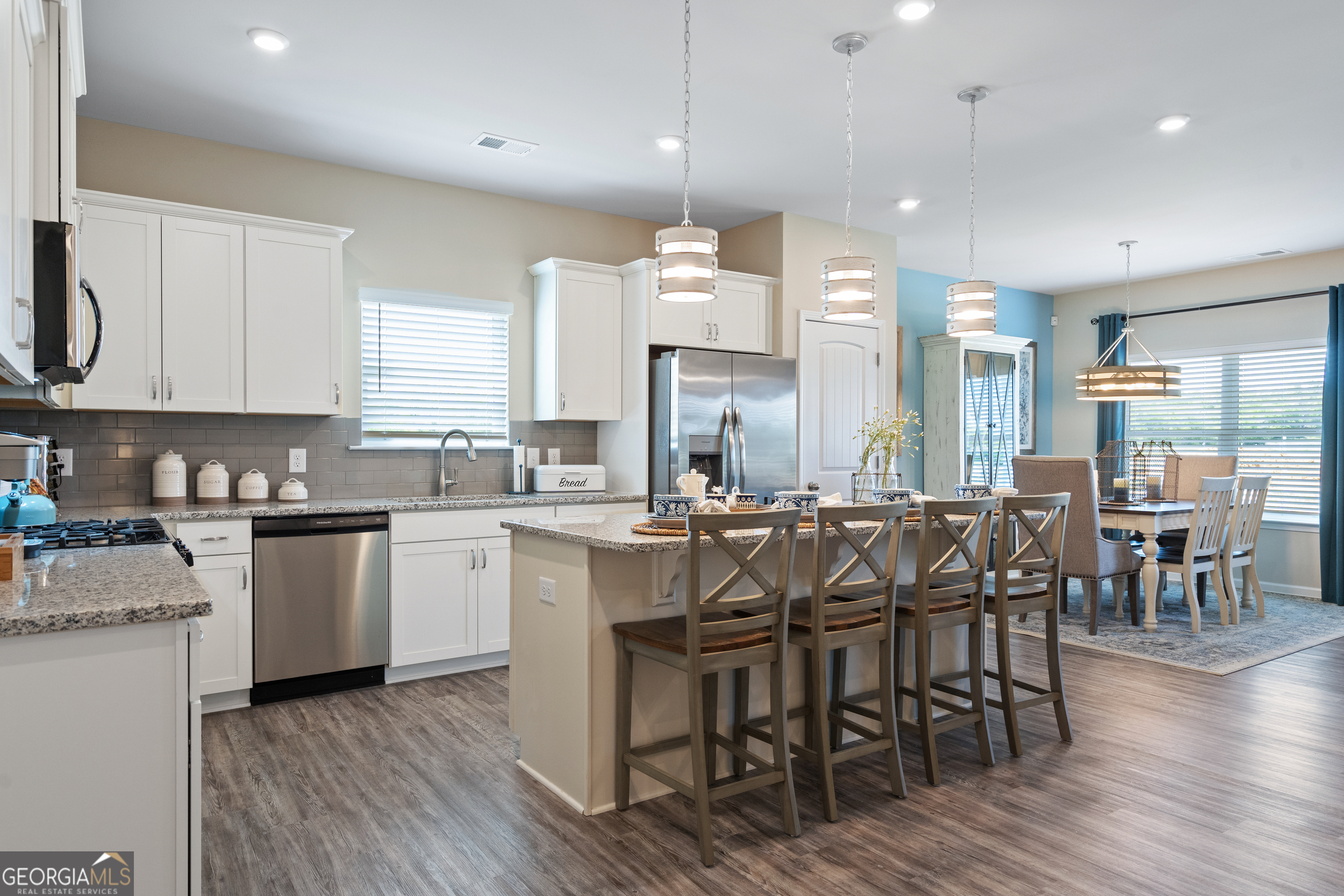 256 Shantz Way, Unit (LOT A45) Byron, GA 31008 - Photo 8 of 25 a large kitchen with cabinets wooden floor white stainless steel appliances and chairs