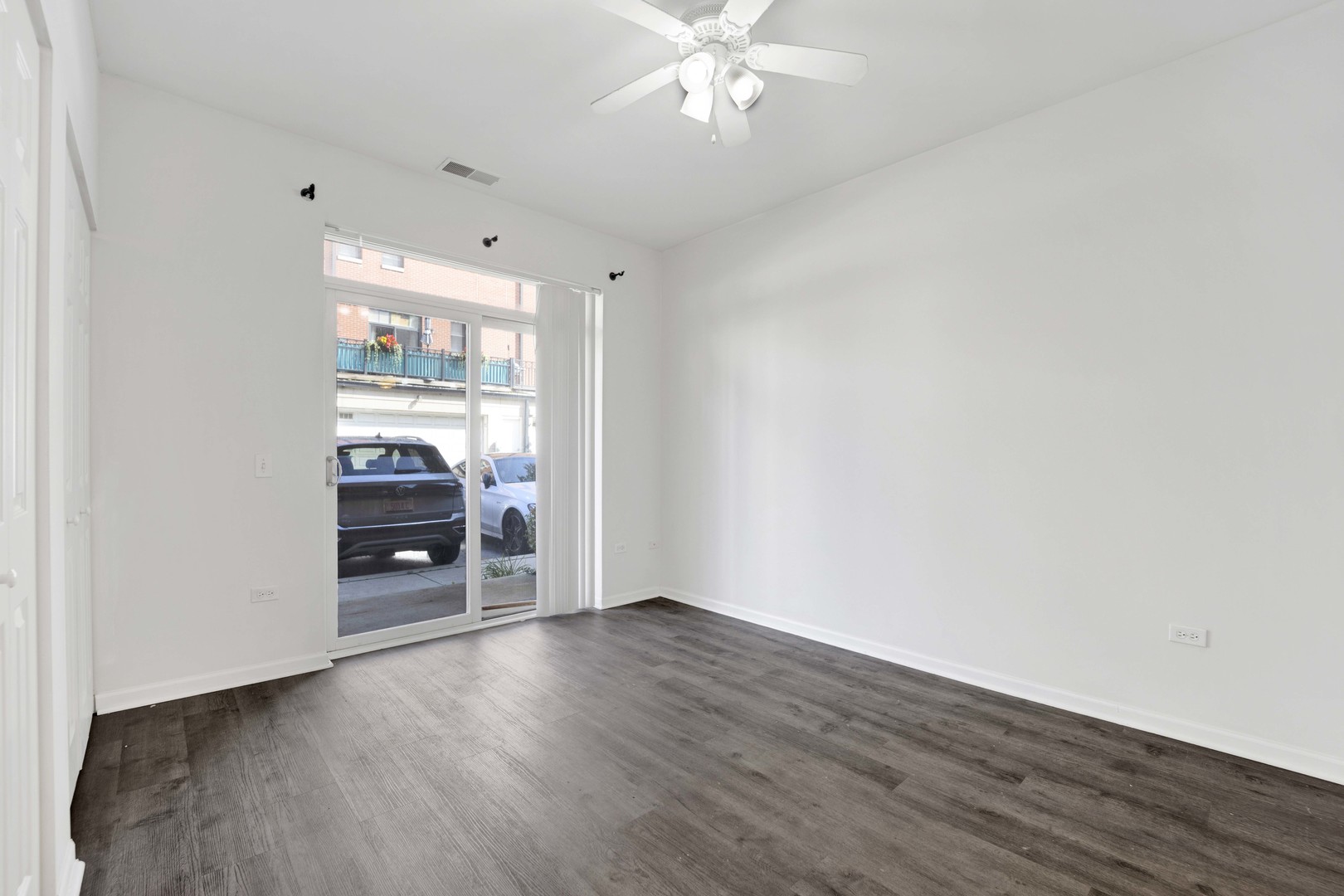 948 West 15th Place, Unit 1B Chicago, IL 60608 - Photo 14 of 59 a view of an empty room with a window and wooden floor