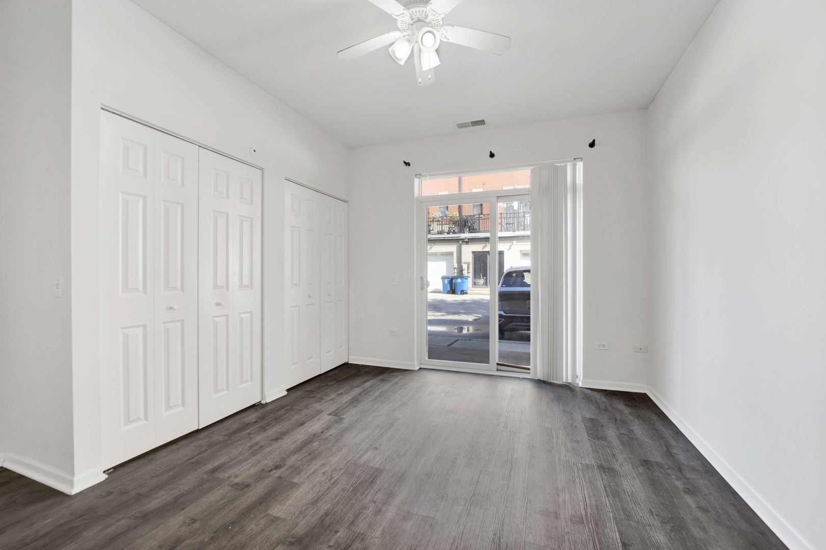 948 West 15th Place, Unit 1B Chicago, IL 60608 - Photo 15 of 59 a view of a room with wooden floor a ceiling fan and windows
